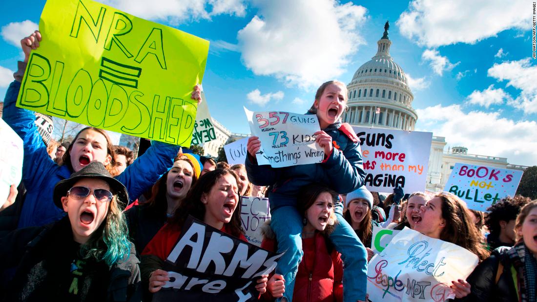 Students participate in a rally with other students from DC, Maryland and Virginia in their Solidarity Walk-Out to urge Republican leaders in Congress "to allow votes on gun violence prevention legislation." on Capitol Hill in Washington, DC, March 14, 2018. Students across the US walked out of classes on March 14, in a nationwide call for action against gun violence following the shooting deaths last month at a Florida high school. The nationwide protest is being held one month to the day after Nikolas Cruz, a troubled 19-year-old former student at Stoneman Douglas, unleashed a hail of gunfire on his former classmates. / AFP PHOTO / JIM WATSON (Photo credit should read JIM WATSON/AFP/Getty Images)